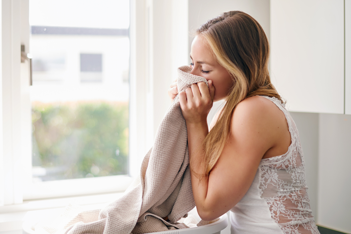 Woman Smelling Fresh Clean Beige Towel 1200X800