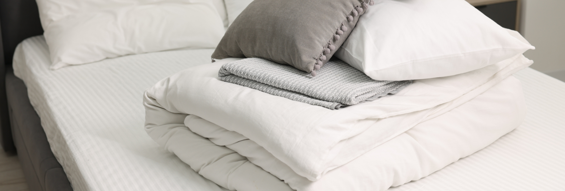 White Folded Bedding On An Semiempty Bed 1920X650